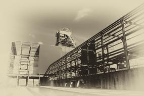 Vintage landscape with the industrial coal mine, under the sky with clouds