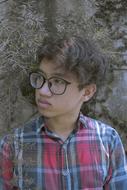 curly haired child boy in glasses portrait