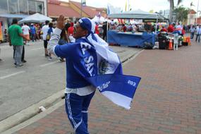 People walking on the street of El Salvador, among the buildings