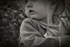 black and white, baby in panama hat outdoors