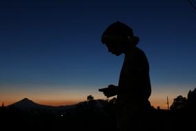 Silhouette of the person, on the beautiful landscape, at colorful, gradient sunset