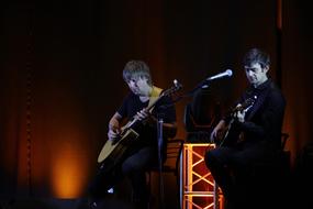 men play music on stage