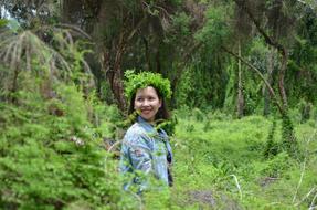 girl with a green wreath in the forest