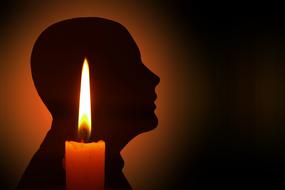 Silhouette of the person, behind the candle, at dark background, clipart