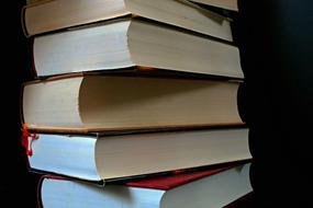 Stack of the colorful literature books, at black background