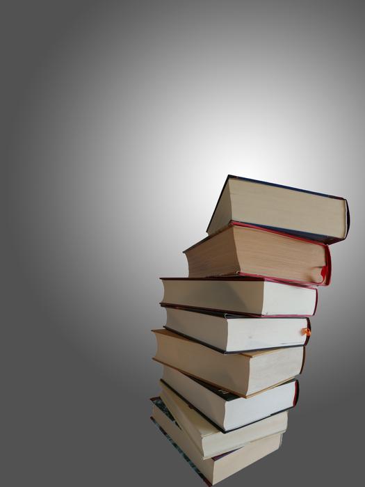 stack of thick books at grey background