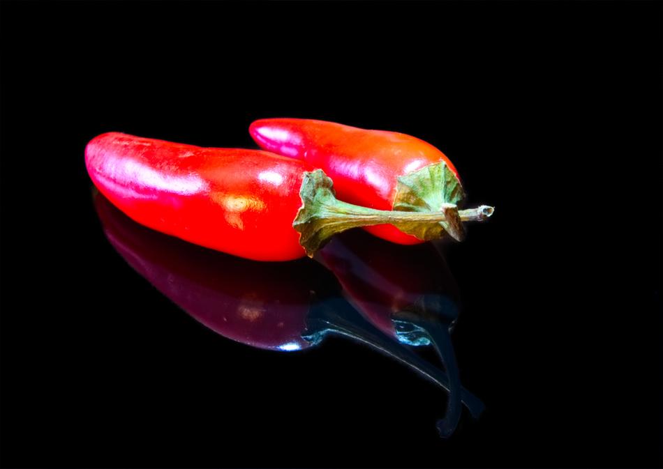 delicious juicy peppers on a black background