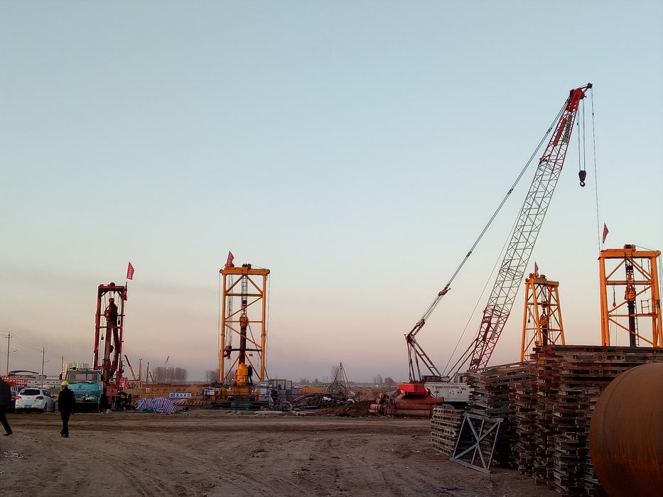 Industrial landscape with the cranes, at colorful sunset