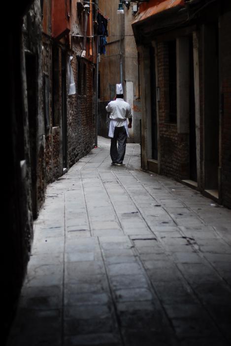 Cityscape of the Italian street with pavement, with the man, among the buildings