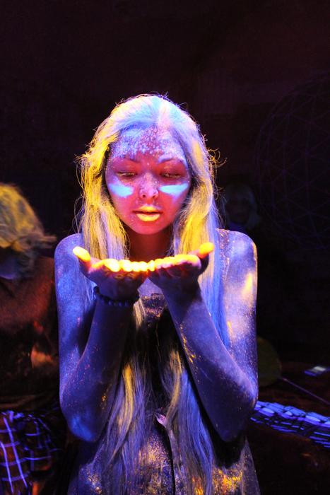 neon purple powder on the girl at the festival of Holi
