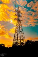 high voltage tower in yellow dusk