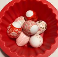 Colorful holiday eggs in a red plate