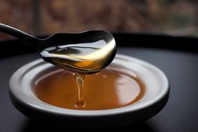 sweet thick honey drips from the spoon