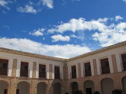 big house in clouds and blue sky