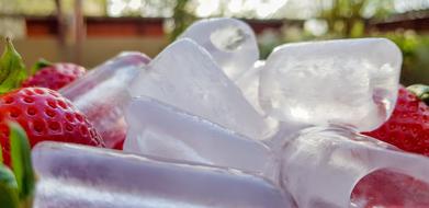 cold ice cubes in strawberries