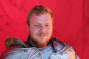 a man in armor with a red background