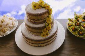 beautiful cream cake decorated with yellow flowers