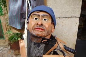 mannequin head in bicycle basket, festival, Spain