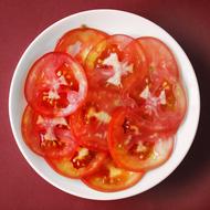 thinly sliced tomatoes in a plate
