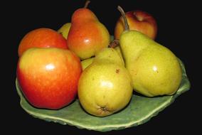 ripe pears and apples on a plate