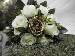 white roses and dry ones in a bouquet