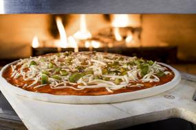 Cheese pizza by the fireplace