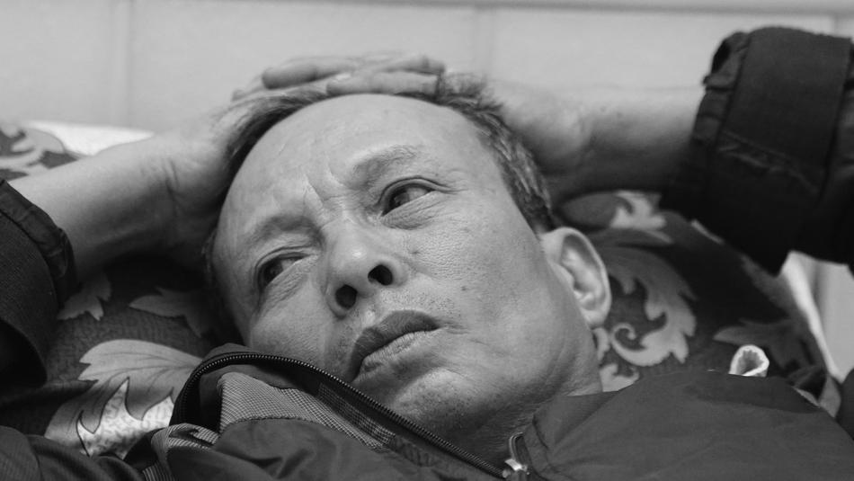 Black and white portrait of the man laying, in Vietnam