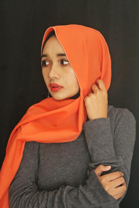 Portrait of the Indonesian woman with make-up, in orange cover