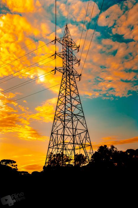 high voltage tower in yellow dusk