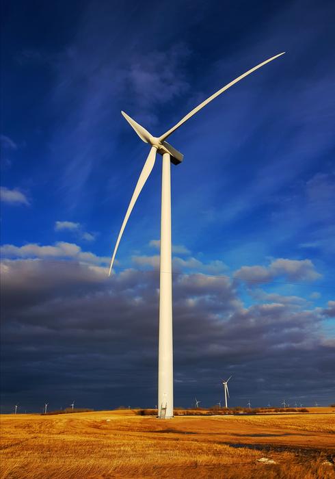 storm clouds over wind turbines in the field
