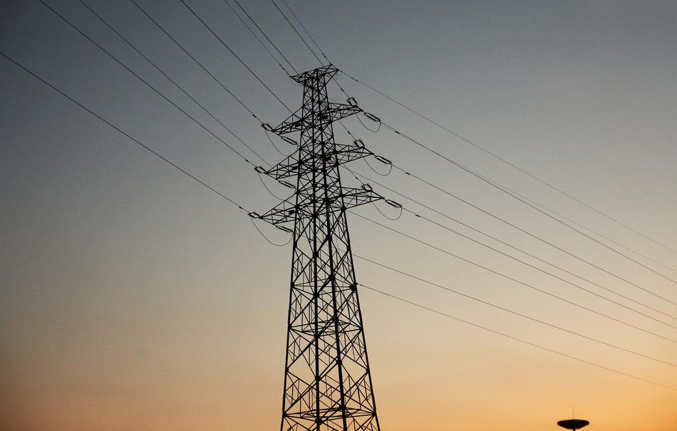 Electricity tower with the cables, at colorful and beautiful, gradient sunset on background