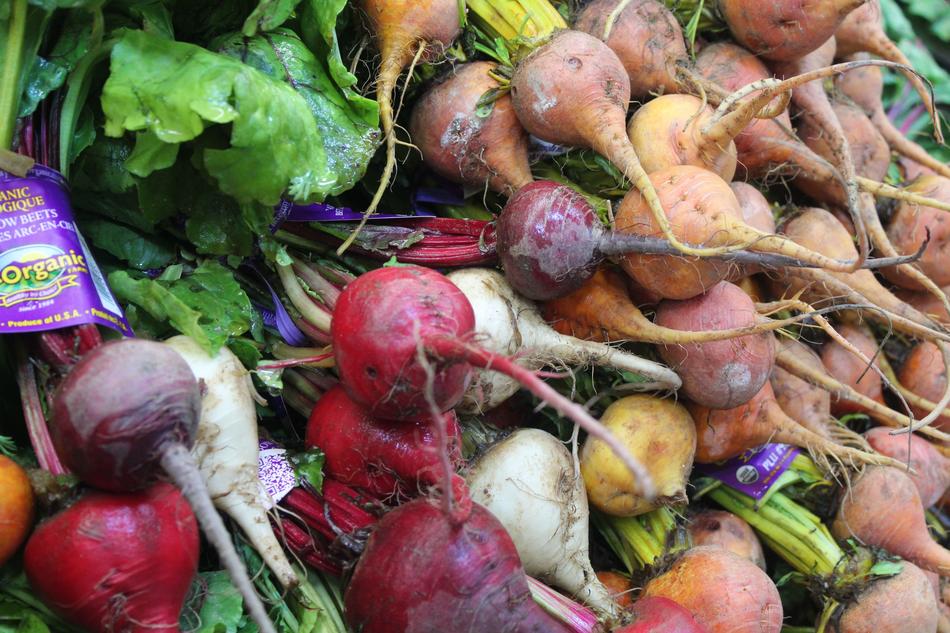Fresh vegetables with roots at the market