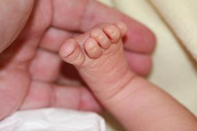 baby's foot in mom's hand