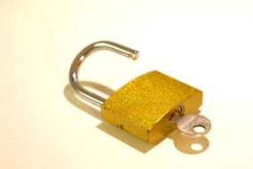 a gold key lock on the table