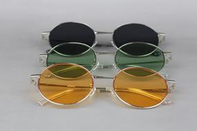 There are a lot of colored glasses on the table