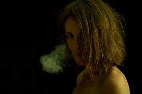 girl with smoke next to her face