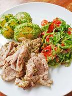 cooked lamb with vegetables on a plate