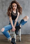 beautiful girl posing in torn jeans