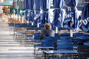 man sits on blue chairs