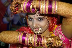 a girl in gold bracelets and jewelry