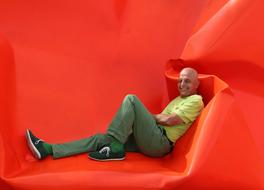 there a man sitting on red