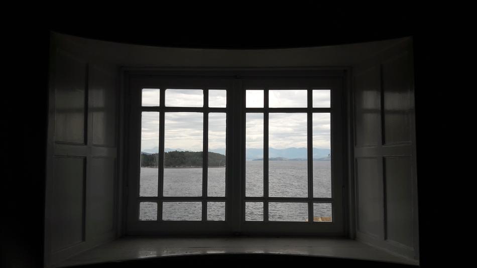 calm grey sea view through grated Window