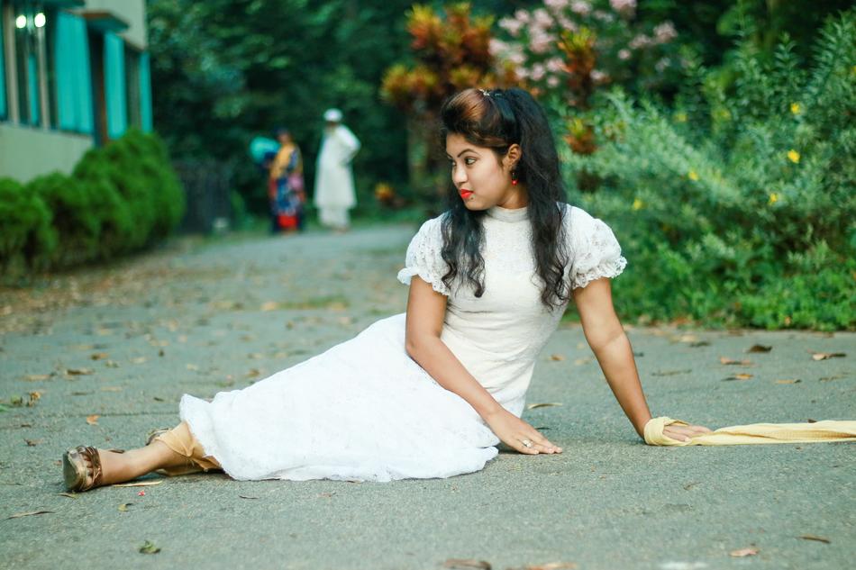 the girl in the white dress is sitting