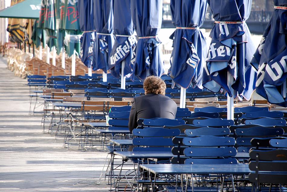 man sits on blue chairs