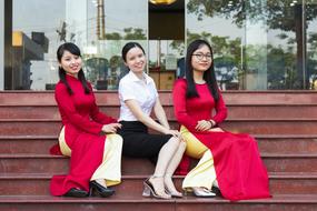 girls sitting on the stairs of a restaurant