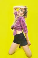 blonde posing on yellow background