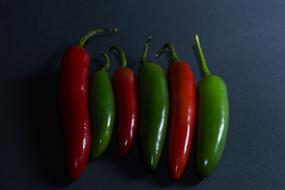 green and red hot peppers on the table