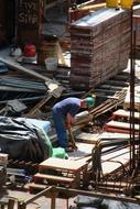 a worker in a green helmet at a construction site