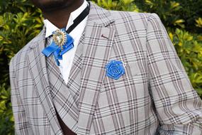 checkered mens suit and blue bow tie