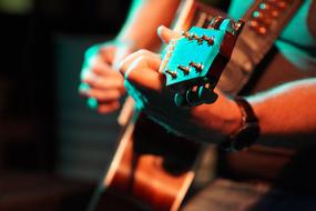 man with a guitar in the spotlights close-up